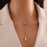 women's tassel necklace
gold water drop necklace
luxury statement jewelry
elegant pendant necklace
fashionable women's accessories
designer tassel jewelry
chic water drop pendant
high-end women's necklace
trendy tassel pendant
sophisticated gold necklace